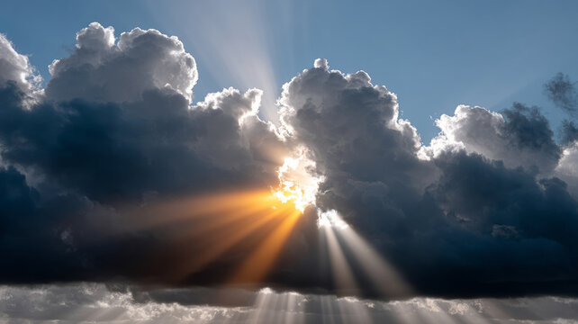 Sunrays breaking through dramatic clouds in the sky.