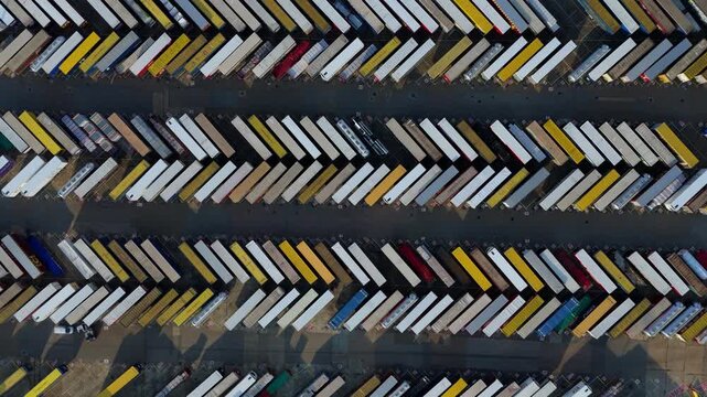 Aerial view of trailers, a vibrant mosaic of whites, yellows, and blues, tightly packed in orderly rows, creating a geometric pattern, Purfleet-on-Thames, England, United Kingdom.