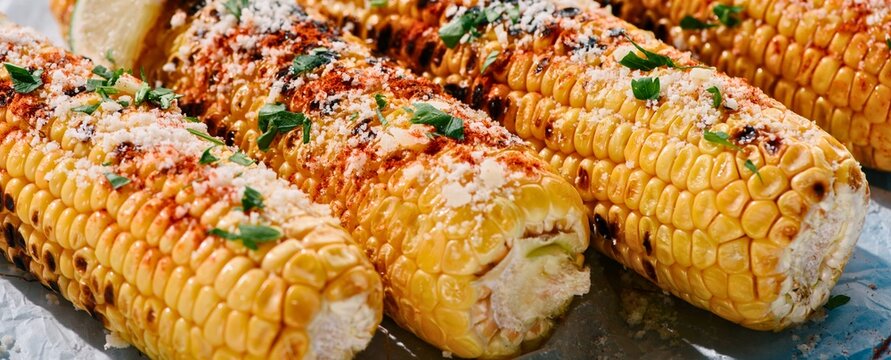 Delicious grilled corn on the cob with seasonings and herbs