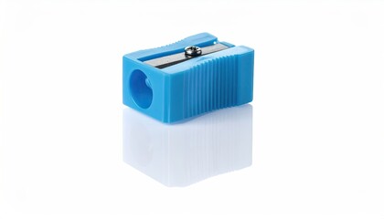 Blue, rectangular pencil sharpener on a white surface