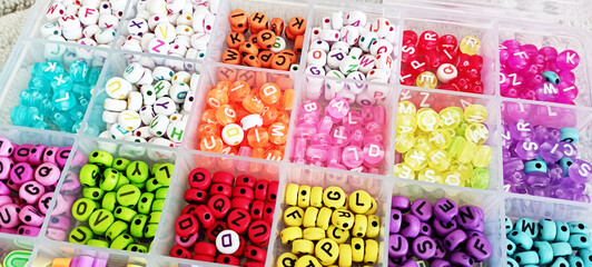 Bracelets with plastic beads. Cute children's accessories, letters and charms in the shape of hearts or flowers. Handmade Friendship Bracelets. Line vector illustration isolated on background