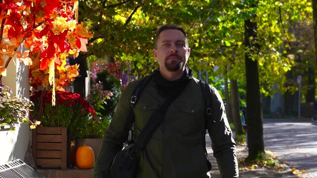 Tourism in Kaliningrad. A man strolls through the autumn streets of Svetlogorsk, surrounded by autumn leaves.
