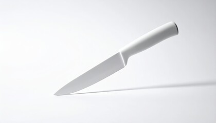 White knife, stark light, casts shadow on a white background
