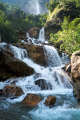 Cascading waterfall tumbles over mossy rocks