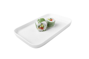 two sushi rolls wrapped in green cabbage on a white rectangular plate