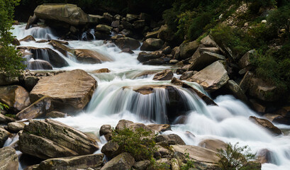 Cascading water flows over smooth river stones
