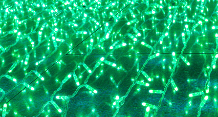 background of holiday colorful green garland for texture and design, festive decoration close up