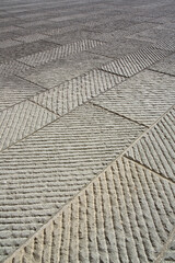 
New carved paving made with chiseled grey sandstone blocks in a italian pedestrian zone - Tuscany-Italy
