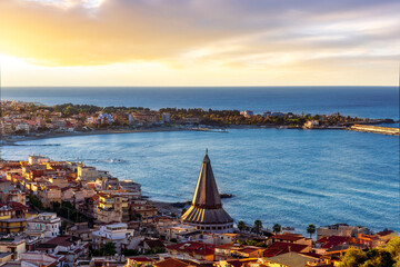 seascape panorama of mediterranean coast landscape with old italian town in golden sunset sun rays and beautiful evening blue sea gulf