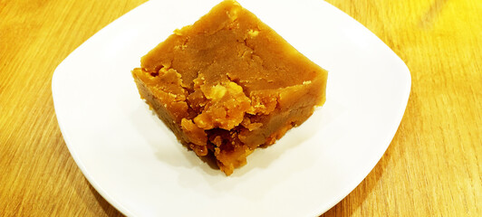 flour halva with hazelnuts on a white plate