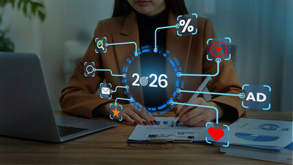 Businessman pointing at upward arrow and 2026 target goal icon, symbolizing future growth, business...