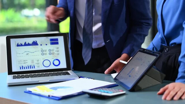 Businessman and team analyzing financial statement Finance task. with smart phone and laptop and  tablet. Wealth management concept