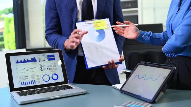 Businessman and team analyzing financial statement Finance task. with smart phone and laptop and  tablet. Wealth management concept