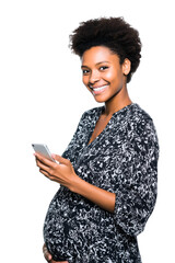 front view of a brunette adult pregnant married woman using her mobile with a happiness; lady isolated over white (transparent) background