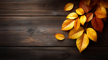 Warm autumn background with golden leaves scattered on wooden surface creating cozy seasonal atmosphere