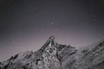Mountain peak under a starry night sky