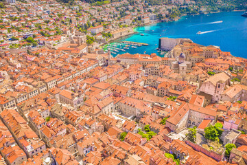 An aerial view of Dubrovnik Old Town, highlighting its unique city center, historic stone buildings, and characteristic red rooftops, showcasing the beauty of medieval Mediterranean place