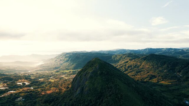 Aerial view of the majestic green mountains and valleys under the soft glow of the morning sun, Soppeng, Sulawesi Selatan, Indonesia.