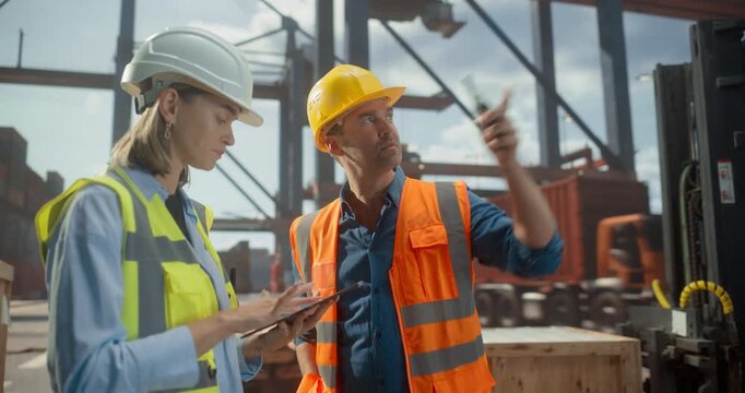 Male and Female Workers in Safety Gear Oversee Port Logistics Using a Tablet and Radio. Cargo Operations Documentation and Container, loading, Unloading with Cranes for furhter Product Shipment