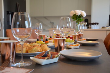 Elegant Dining Table Setting with Wine Glasses and Appetizers in Modern Kitchen Interior for Stylish Home Entertaining and Food Photography
