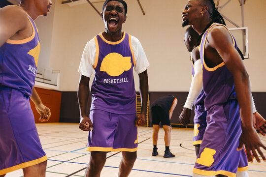 Basketball team chanting passionately in victory celebration