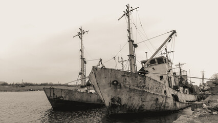 sunken and broken ships in a destroyed port in Ukraine during the war