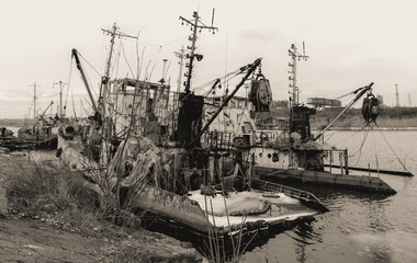 sunken and broken ships in a destroyed port in Ukraine during the war