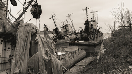 sunken and broken ships in a destroyed port in Ukraine during the war