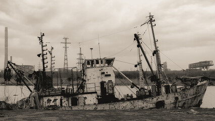sunken and broken ships in a destroyed port in Ukraine during the war