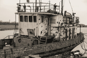 sunken and broken ships in a destroyed port in Ukraine during the war
