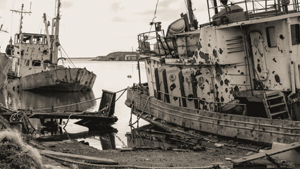 sunken and broken ships in a destroyed port in Ukraine during the war