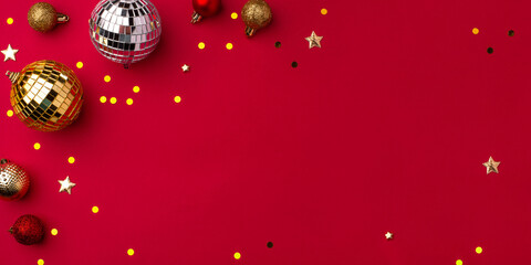 Festive Christmas gold ornaments on a red background.