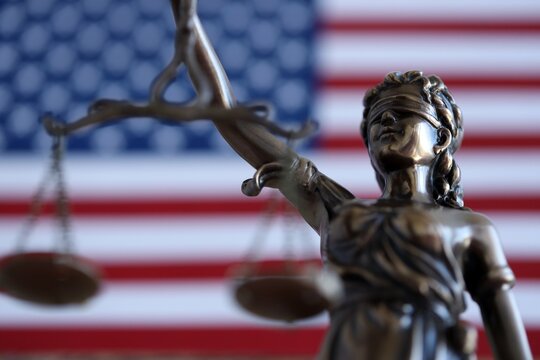 United States of America in Law and Justice statue of Lady Justice with USA flag close up