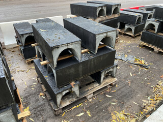 Precast Concrete Cable Troughs with black waterproofing folded in city street. Renovation urban...