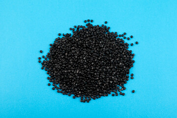 Heap of Black polymer granules, primary plastic resin in pellet form. Black masterbatch or PE pellets. Granulated plastic polymer