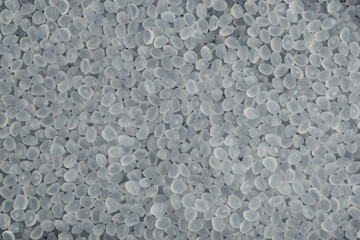 Virgin polypropylene pellets or PP granules, close-up. Base polymer for production of plastic packaging. Granulated plastic polymer