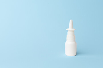 Nasal spray bottle on a soft blue background, showcasing a minimalist design with copy space for branding or advertising purposes. copy space