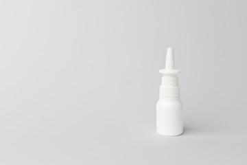 Nasal spray bottle positioned on a minimalistic background, showcasing its sleek design and functionality for health and wellness applications. copy space.