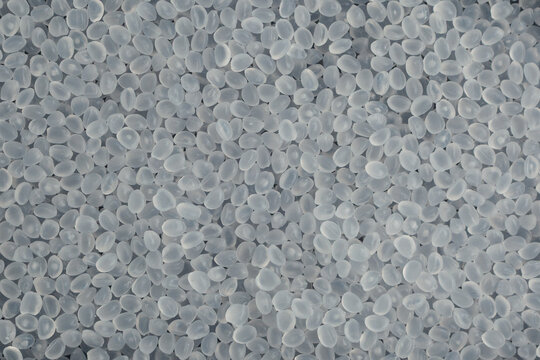 Virgin polypropylene pellets or PP granules, close-up. Base polymer for production of plastic packaging. Granulated plastic polymer