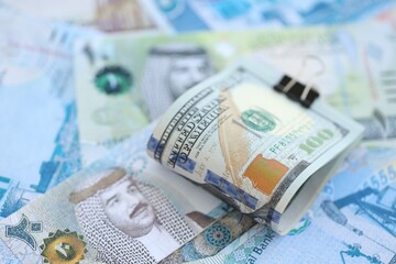 Bahraini dinar currency money bills and bunch of us dollar banknotes close up. The concept of economics and currency exchange