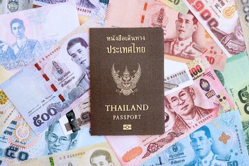 Thai baht currency money bills and passport close up. The concept of travel and vacation