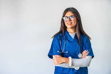 Smiling female doctor wearing glasses and blue scrubs