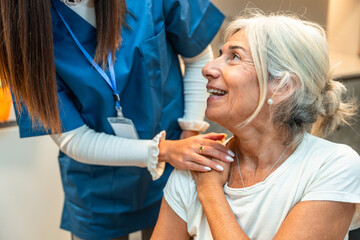 Healthcare worker providing support to senior woman