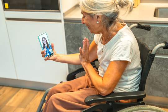 Senior woman in wheelchair having telehealth video call