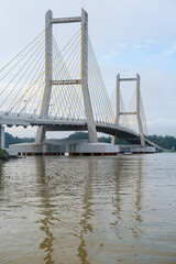 Cable-stayed bridge spanning across Kendari Bay, showcasing modern engineering and elegant design that connects the city’s shores with scenic reflection on calm waters.