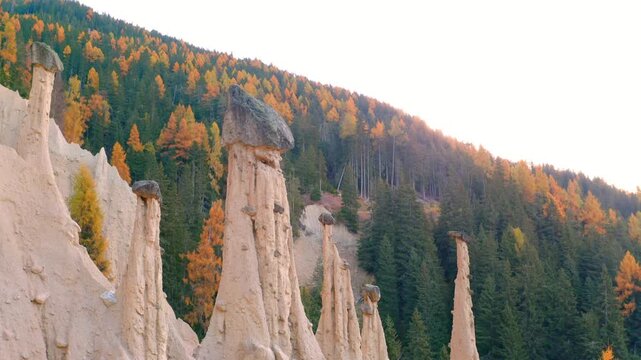 Fantastic 4K&nbsp;video (Ultra High Definition) of Earth pyramids of Platten - Spiky sand towers formed by water erosion and accessed by a woodland trail dotted with sculpture.