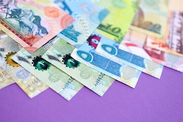 Bahraini dinar money bills in big amount on purple close up. Finance and banking concept