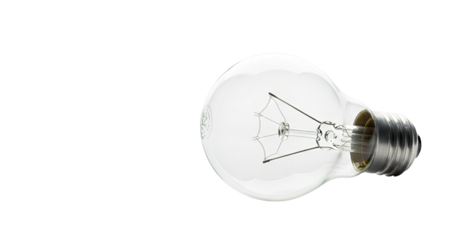 A clear glass incandescent lightbulb is isolated on a stark black background