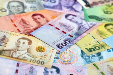 Thai baht currency money bills. The current banknotes lies on table in big amount close up