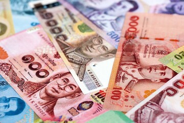 Thai baht currency money. The current banknotes lies on table in big amount close up